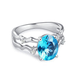 Glojewels Unique Twisted Orbit Blue Natural Topaz Oval Cut Silver Ring
